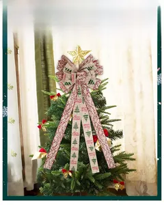 Detail of Christmas tree topper bow with linen texture and red Merry Christmas print