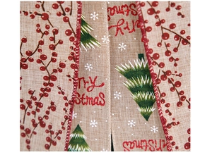 Close-up of burlap Christmas ribbon with Merry Christmas text, trees and red berries