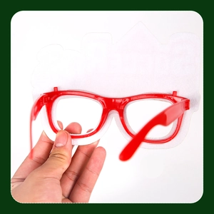 Close-up of red plastic party soccer glasses with white felt cloud decoration