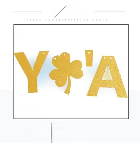 Detail of St. Patrick's Day gold glitter clover and letter garland made of non-woven fabric