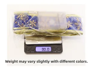 Blue LED Christmas ribbon with gold snowflakes being weighed on a digital scale