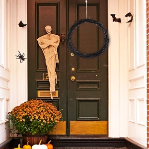 Close-up of black natural vine wreath base hanging on a door for Halloween decor