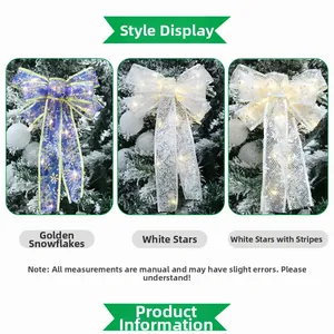 Detail of LED Christmas bows with golden snowflake and star patterns on tree
