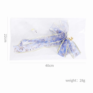 Detail of blue LED Christmas ribbon bow with gold snowflakes and size measurements