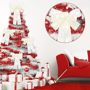Detail of white LED Christmas bow hanging on a red tree with warm glow effects