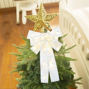 Detail of a lighted Christmas tree topper with gold hollow star and LED white bow