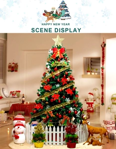Detail of Christmas tree with red bows, gold star topper, and white picket fence base
