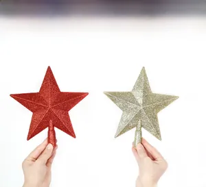 Detail of red and gold glitter Christmas tree star topper with conical base support