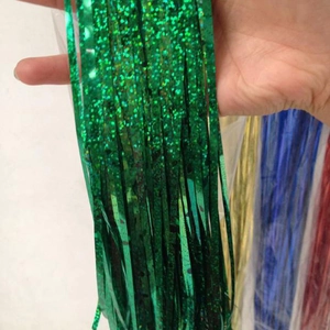 Detail of emerald green tinsel foil fringe curtain with shimmering sequins for party decor