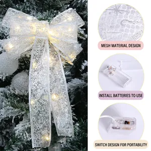LED lighted Christmas bow topper with snowflake stars for festive tree decoration