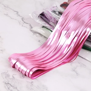 Close-up of matte pink tinsel curtain fringe for party backdrop wall decorations