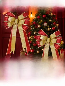 Detail of red and gold glitter Christmas bows on a festive tree background