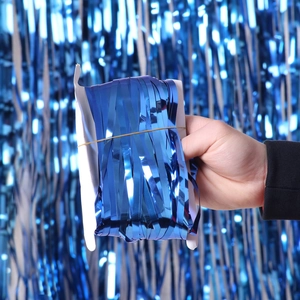 Blue laser metallic foil fringe curtain for party wall decoration shown in hand