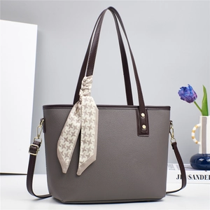 Gray lychee leather bucket tote bag with brown handles and a stylish houndstooth scarf