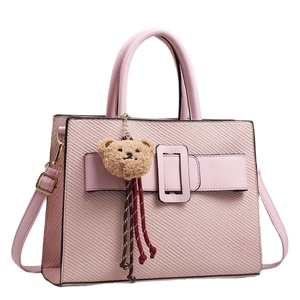 Pink faux leather tote bag with woven texture, buckle detail, and a cute bear charm