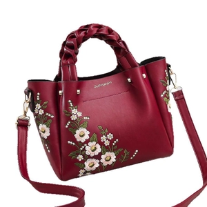 Elegant wine red handbag with floral embroidery and woven handles for women