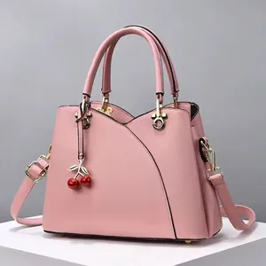 Sac à main macaron rose avec patchwork en cuir, breloque cerise et bandoulière chic