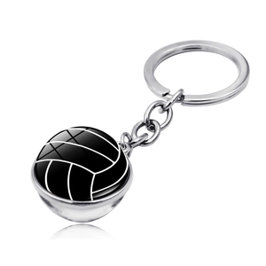 Close-up of a volleyball glass cabochon keychain with polished silver metal finish