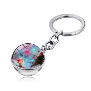 Macro shot of solar system nebula glass ball keychain with polished metal ring