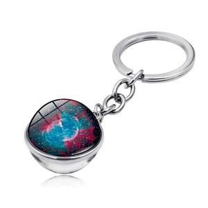 Macro detail of solar system glass ball keychain with nebula pattern and silver ring