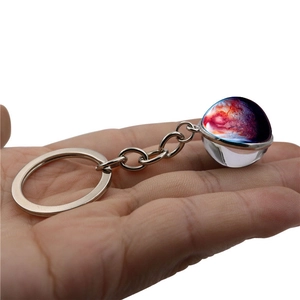 Handheld galaxy glass ball keychain with vibrant purple and red nebula pattern details