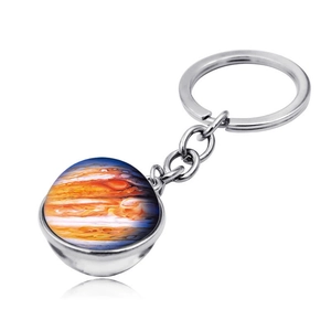 Macro view of double-sided glass galaxy keychain with Jupiter planet design and silver ring