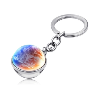 Detailed view of galaxy nebula glass sphere keychain with silver alloy ring and reflection
