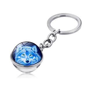 Detailed view of silver wolf head keychain with a glowing green eye glass cabochon