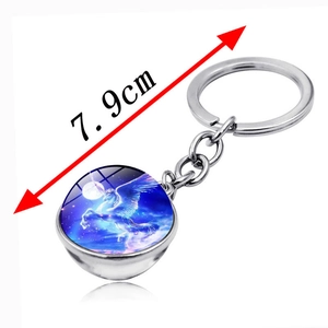 Unicorn glass ball keychain in silver metal featuring a mystical starry night pendant