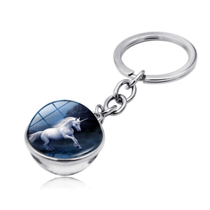 Detailed view of unicorn glass ball keychain with polished silver metal link chain