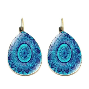 Macro detail of teardrop earrings with blue mandala pattern and gold leverback hooks