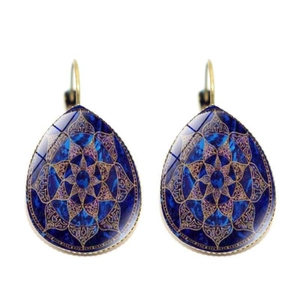 Detailed view of teardrop yoga mandala earrings with blue gemstone and gold vintage frame