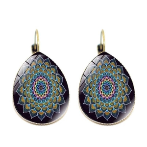 Detail of bohemian teardrop earrings featuring golden metal and colorful mandala patterns