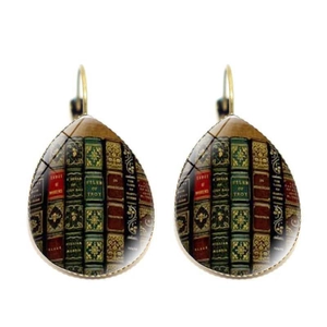 Detailed view of vintage library book spine pattern on teardrop dangle earrings with gold hooks