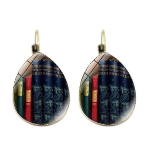 Detail view of teardrop earrings with vintage book spine pattern and bronze hooks