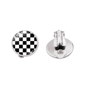 Detailed view of checkered black and white clip-on earrings with silver metal back