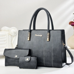 Black three-piece tote bag set with matching clutch and wallet in premium faux leather