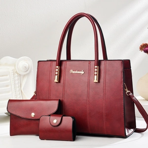 Three-piece burgundy tote bag set with textured leather and minimalist vertical stitching