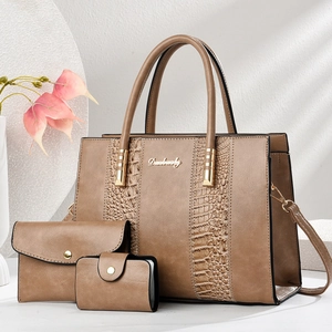 Close-up of three-piece brown stone pattern tote set with gold metal logo and textures