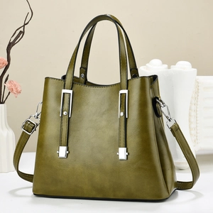 Elegant dark green leather tote bag with textured finish and silver metal accents