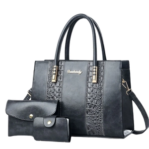 Three-piece black handbag set with crocodile pattern and stylish golden metal logo details