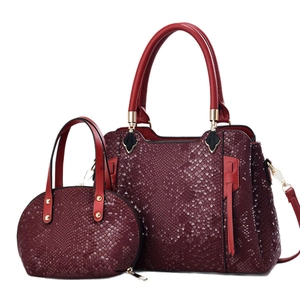 Burgundy snakeskin embossed 2-piece handbag set with gold hardware and tassel accents