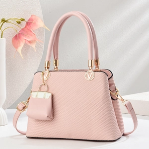 Pink macaron textured handbag with gold V-metal hardware and matching mini charm pouch
