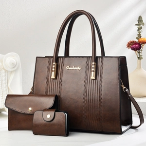 Three-piece brown faux leather tote set with shoulder bag and clutch in an elegant setting