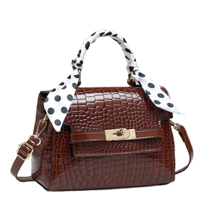 Brown crocodile texture handbag with gold buckle and black dot print silk scarf wrap