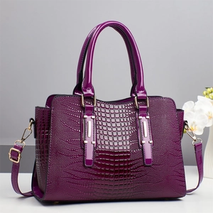Fashionable purple crocodile embossed tote bag with gold hardware and shoulder strap