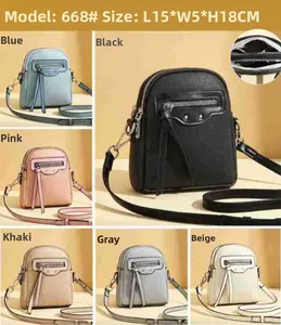 Close-up of pebble leather crossbody bag with front tassel zipper and rivet details