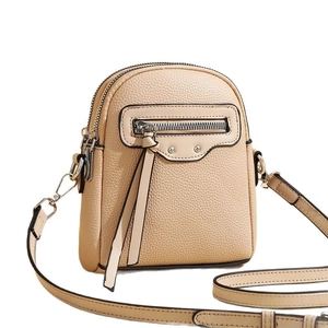 Beige textured leather crossbody bag with silver tassel zippers and adjustable strap