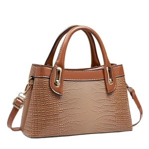 Brown crocodile embossed handbag with glossy patent leather trim and gold hardware detailing