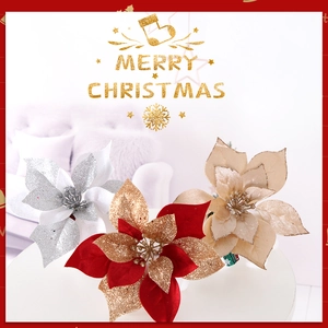 Close-up of sparkling red, silver and gold poinsettia flowers for Christmas tree decor